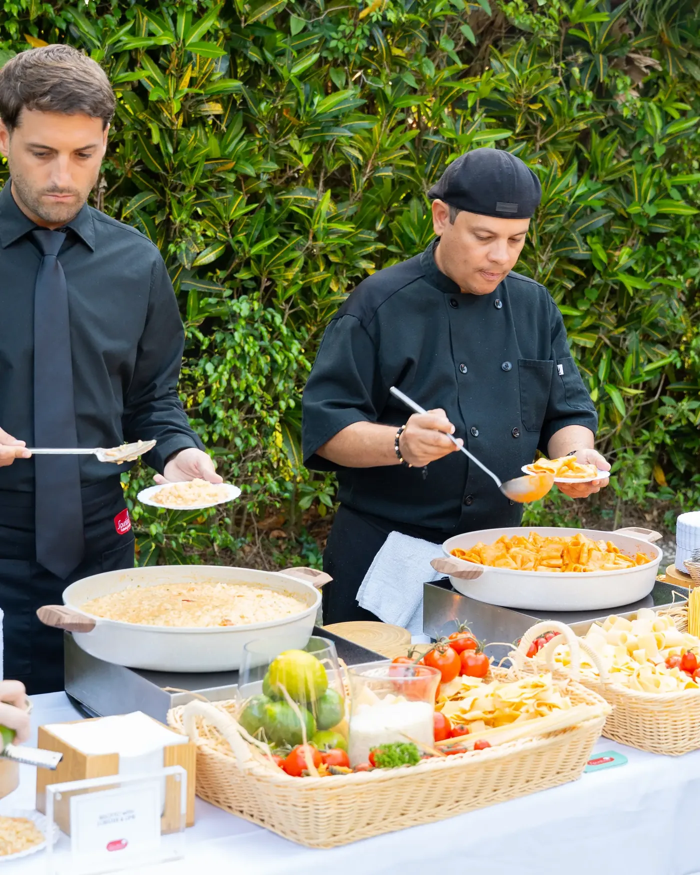 Chefs working a live pasta and risotto action station at a Las Vegas event